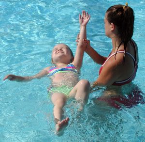 "Diane Raver | The Herald-Tribune PROGRESS: One little girl gets comfortable floating on her back."